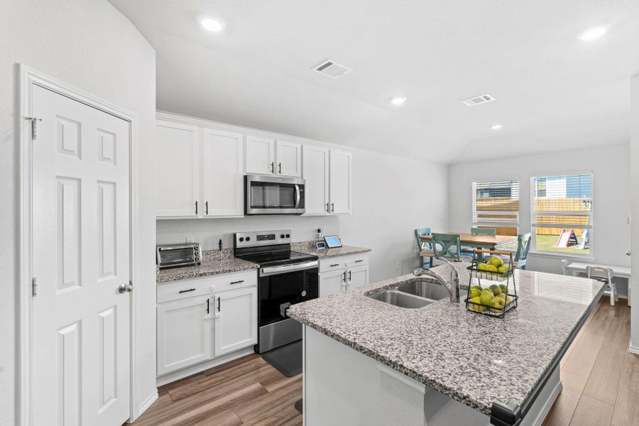 A pristine culinary space features granite counters, stainless steel appliances, and durable flooring, ideal for everyday living. A pristine culinary space features granite counters, stainless steel appliances, and durable flooring, ideal for everyday living.