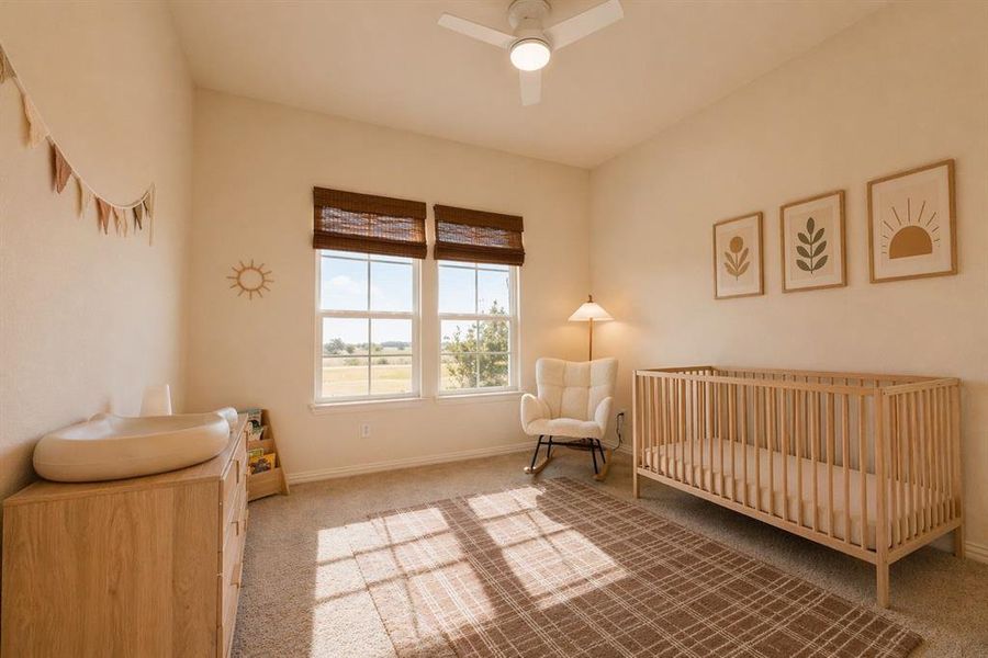 Bright room featuring double windows with woven wood blinds, a ceiling fan with integrated lighting, and neutral wall tones