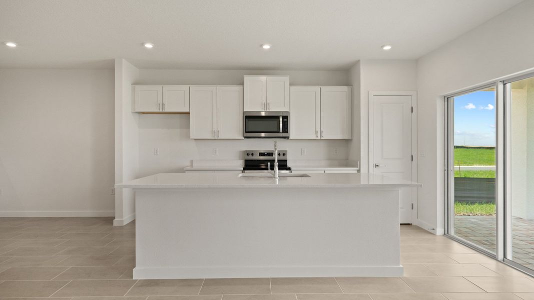 Open kitchen with a large island, natural light, and direct access to the backyard—perfect for cooking and entertaining