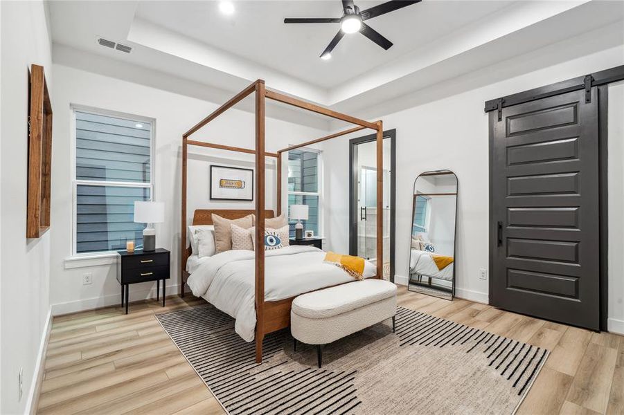 This spacious primary bedroom features recessed tray ceilings, seamlessly leading into the walk-in closet and primary bathroom for ultimate convenience and flow.