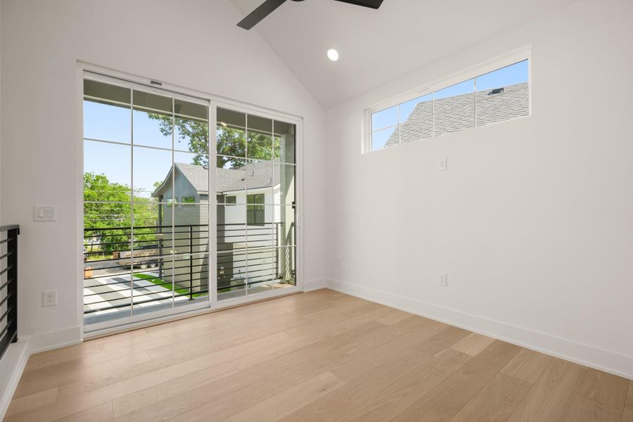 Hardwood floors and a vaulted ceiling create an airy bedroom with abundant natural light. Hardwood floors and a vaulted ceiling create an airy bedroom with abundant natural light.