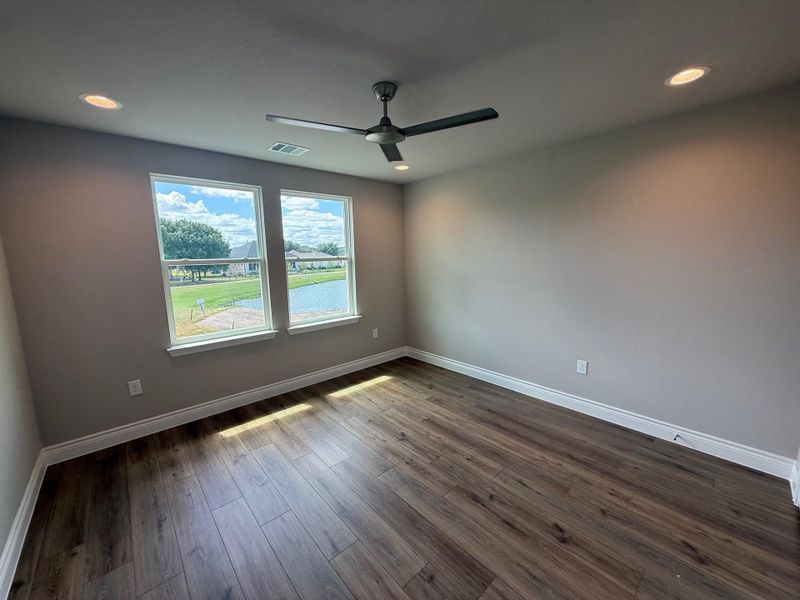 Empty room with recessed lighting, dark wood-style flooring, and a ceiling fan Empty room with recessed lighting, dark wood-style flooring, and a ceiling fan