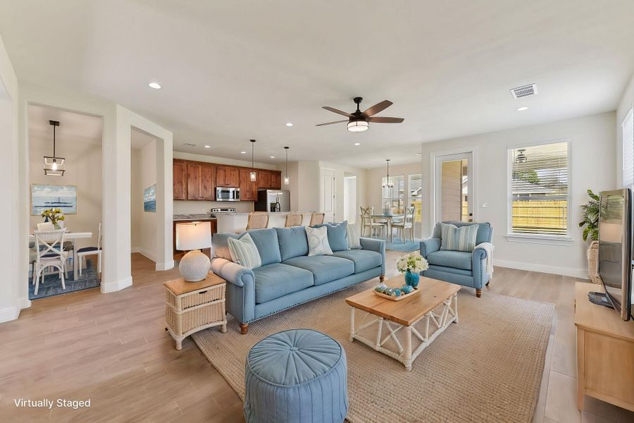 Virtually Staged Living area featuring recessed lighting, visible vents, baseboards, and light wood finished floors