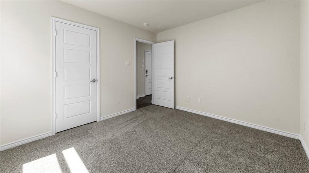 This room features light gray walls and plush gray carpeting
