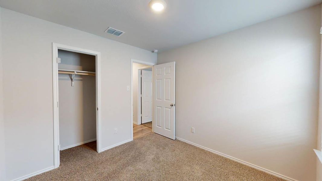 Neutral wall paint with textured carpet flooring