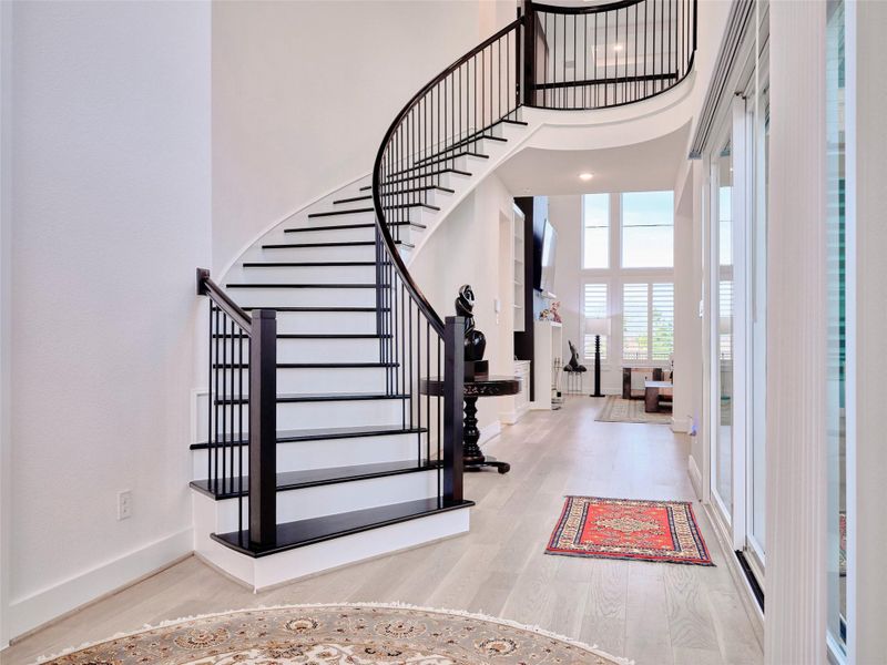 Striking curved staircase with custom detailing. Striking curved staircase with custom detailing.