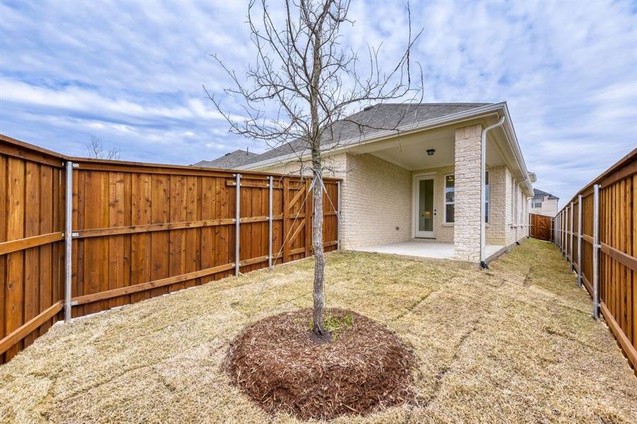 Rear view of house with a patio, brick siding, a fenced backyard, and a shingled roof Rear view of house with a patio, brick siding, a fenced backyard, and a shingled roof
