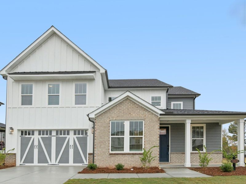 Front exterior of a new home in Vines at Mill Creek - Legacy Series, Braselton, GA, highlighting curb appeal (Image 1).