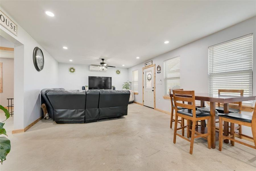 Living area featuring recessed lighting, baseboards, and a ceiling fan