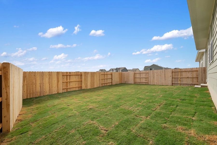 Exterior details and patio area of a home in Lariat, Liberty Hill (Image 18).