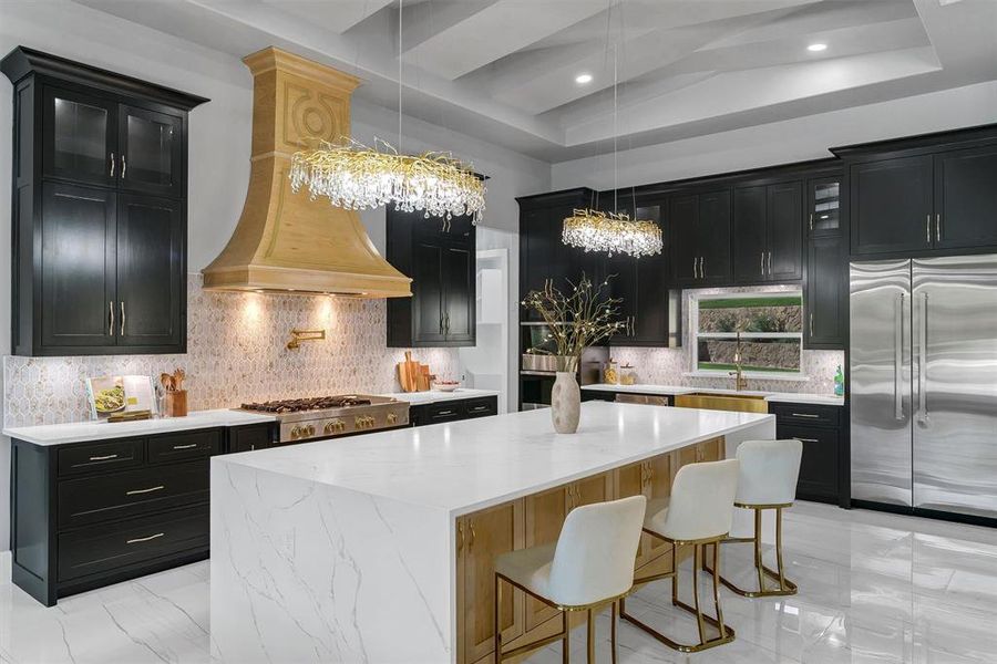 Kitchen featuring a center island, hanging light fixtures, appliances with stainless steel finishes, and decorative backsplash