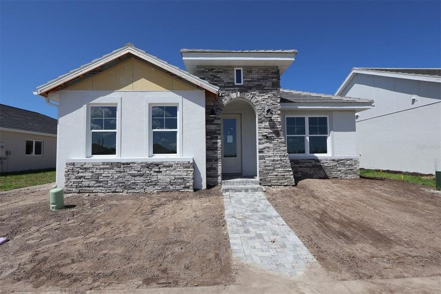 Front exterior of a new home in Vistera of Venice – Cottage Series, Nokomis, FL, highlighting curb appeal (Image 2).