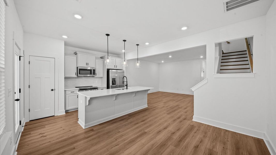 Accomplished layout with a first-class kitchen in this select townhome community at Clayton Crossing by DRB Homes