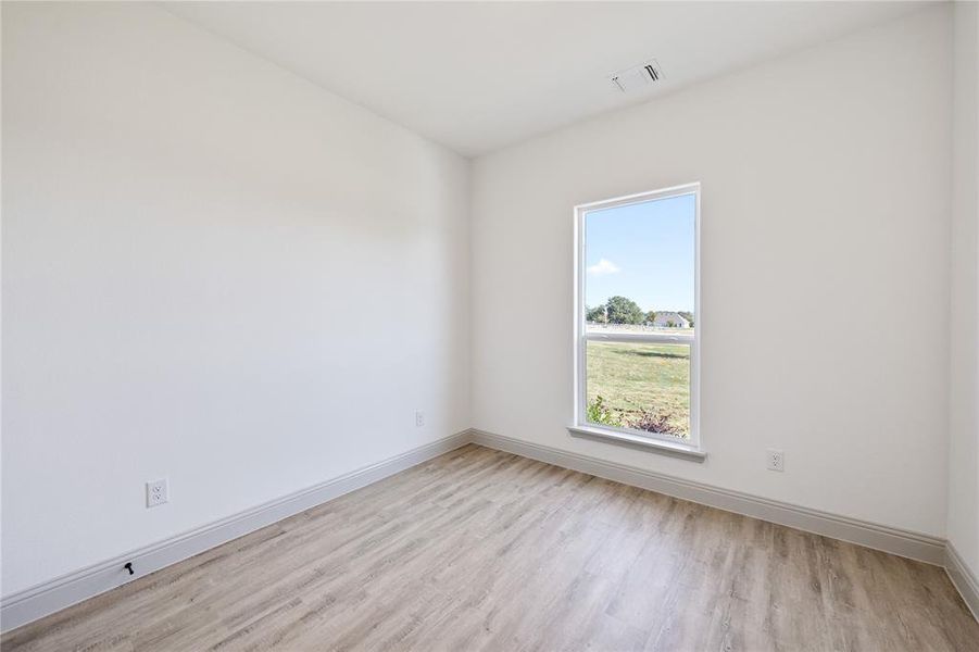 Unfurnished room featuring light wood finished floors
