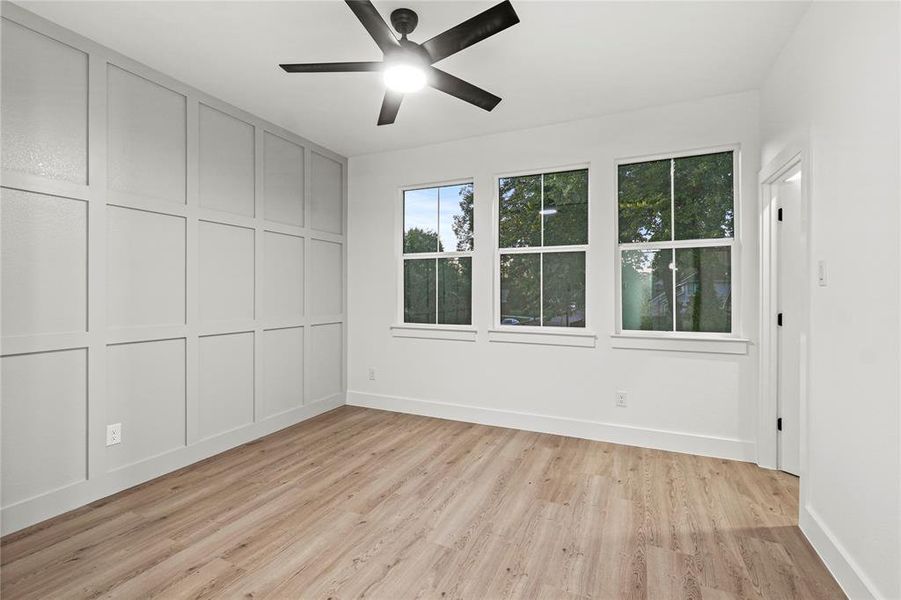 Empty room with light wood-type flooring and ceiling fan