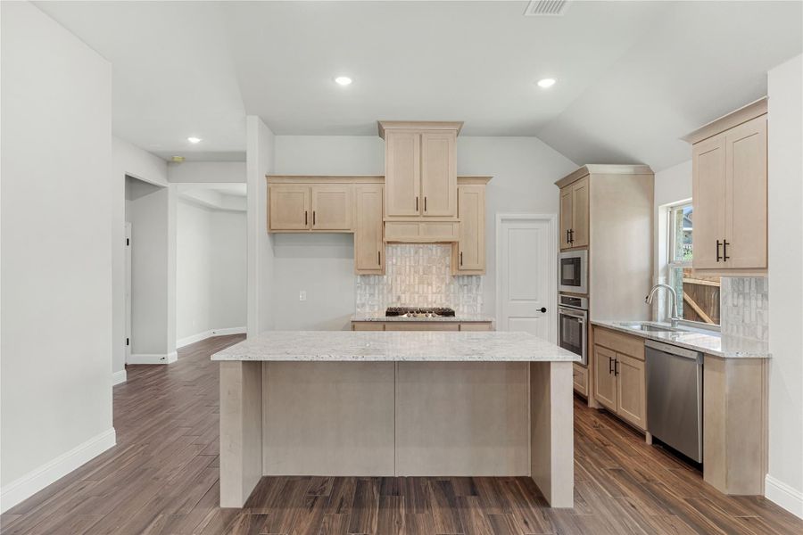 Kitchen with light wood cabinets, center island, granite countertops, and dark hardwood floors Kitchen with light wood cabinets, center island, granite countertops, and dark hardwood floors