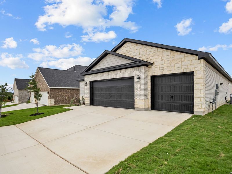 Front exterior of a new home in The Reserve at Potranco Oaks, Castroville, TX, highlighting curb appeal (Image 22).