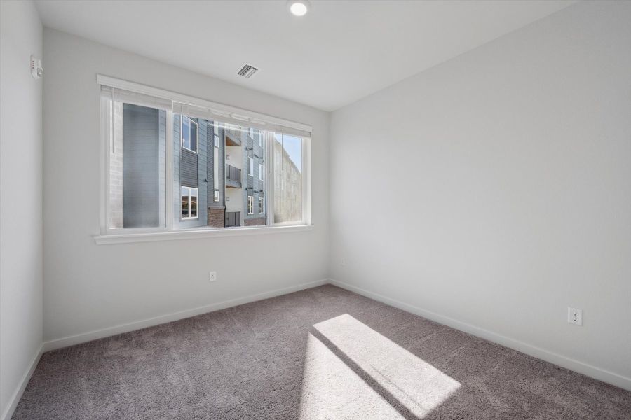 A room with a window and carpet. A room with a window and carpet.