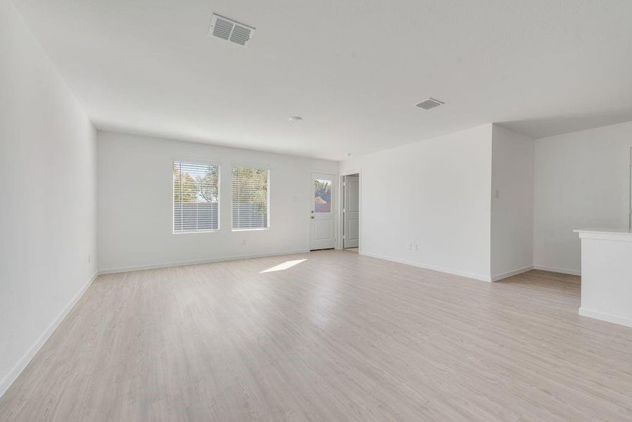 Empty room with light wood finished floors and baseboards