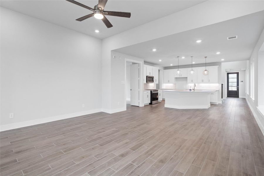 Stunning open-concept design seamlessly connecting the living, dining, and kitchen areas—perfect for both everyday living and entertaining!