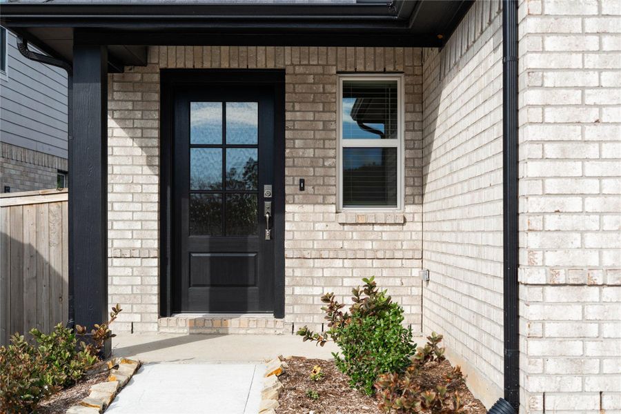 This home is modern elegance with a timeless brick exterior and high quality entry door.