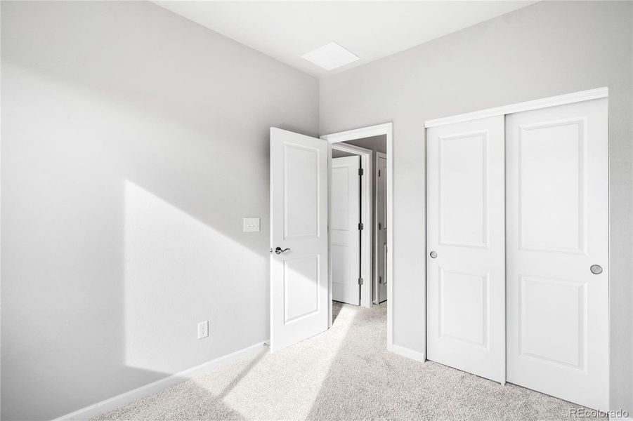 Another view of a secondary bedroom, showing the closet size