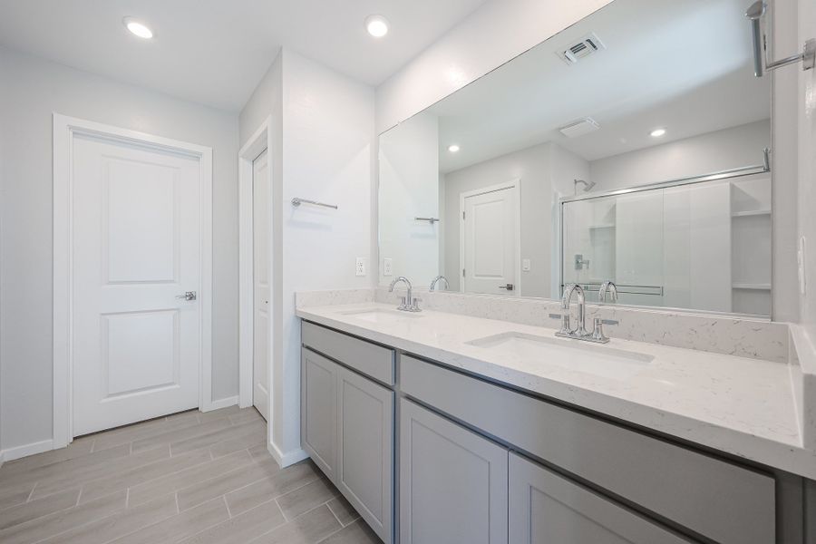 A bathroom with a large mirror. A bathroom with a large mirror.