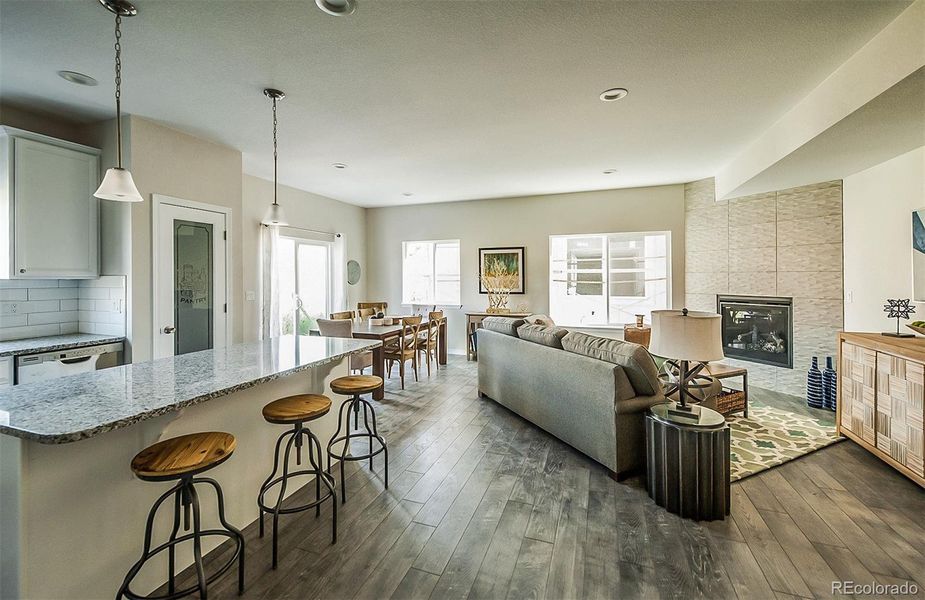 Open concept main level with luxury vinyl floors and fireplace Open concept main level with luxury vinyl floors and fireplace