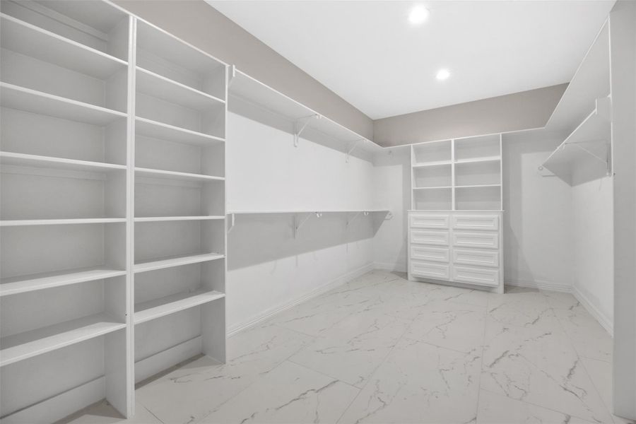 Sample of Home.  primary closet with custom drawers & shelving