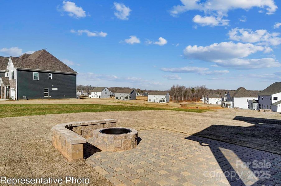 Homesite 36 features a covered porch and the paver patio with firepit