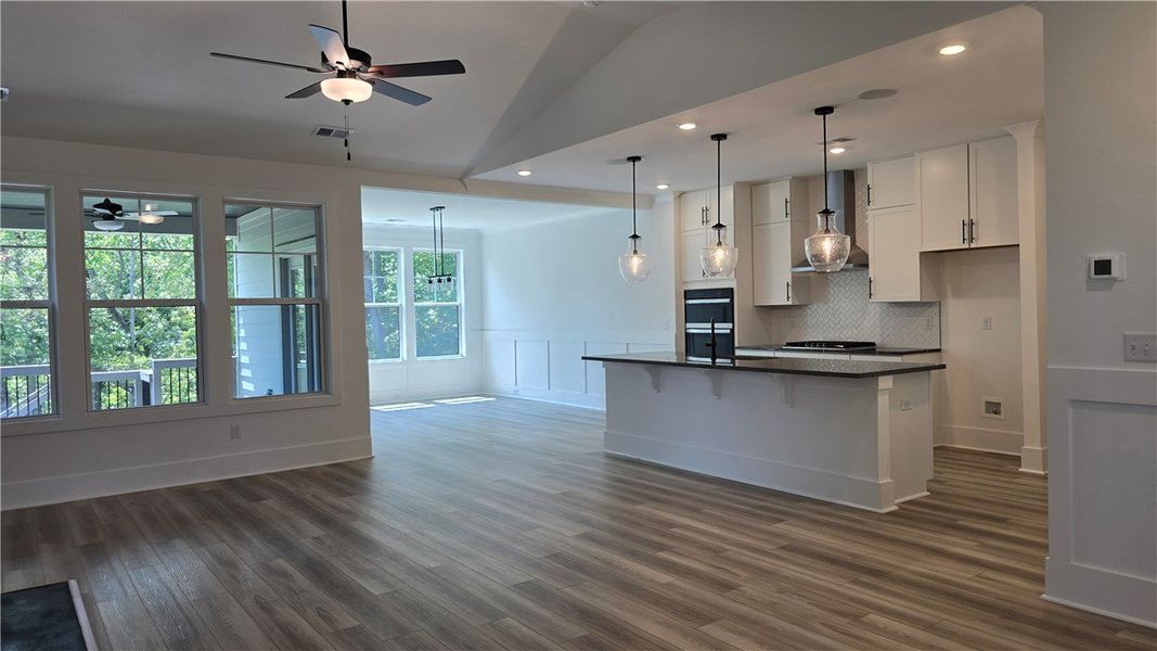 An open-concept living space with sleek flooring a