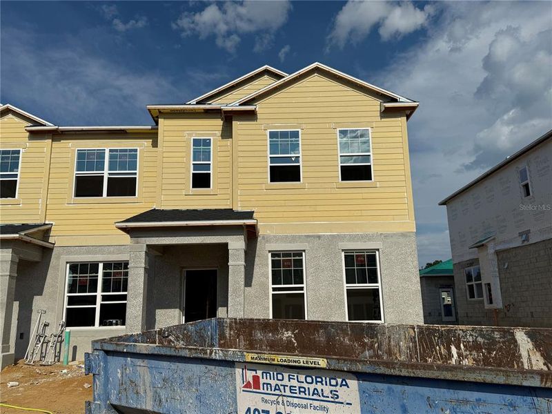 Front exterior of a new home in Emerson Pointe, Apopka, FL, highlighting curb appeal (Image 15). Front exterior of a new home in Emerson Pointe, Apopka, FL, highlighting curb appeal (Image 15).