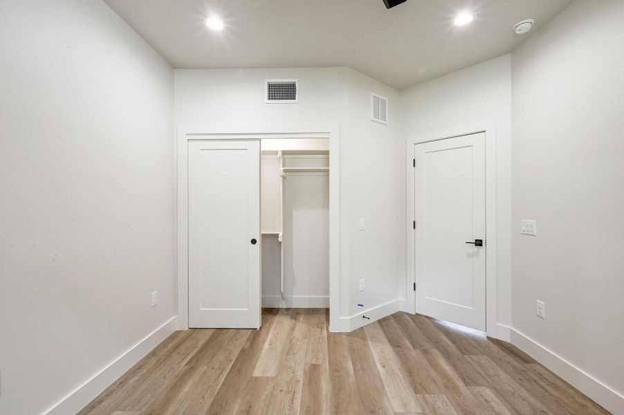 Ample closet space with sliding doors and built-in hanging storage. Ample closet space with sliding doors and built-in hanging storage.