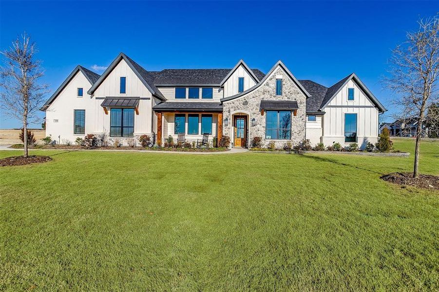 Modern inspired farmhouse with a front yard