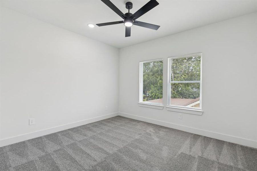 Empty room featuring carpet floors, recessed lighting, and a ceiling fan