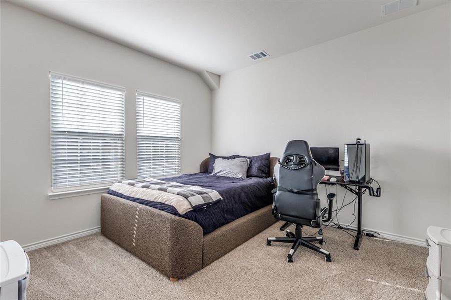 Bedroom with light colored carpet and baseboards Bedroom with light colored carpet and baseboards