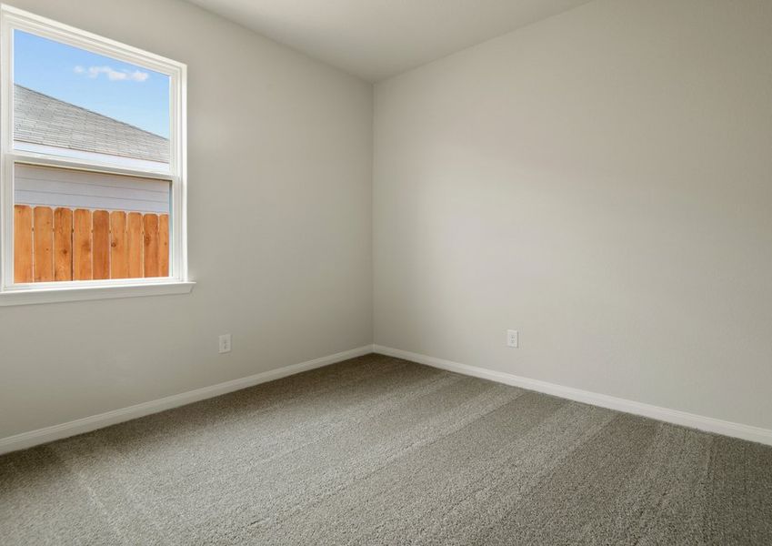 Secondary bedroom with lush carpet flooring