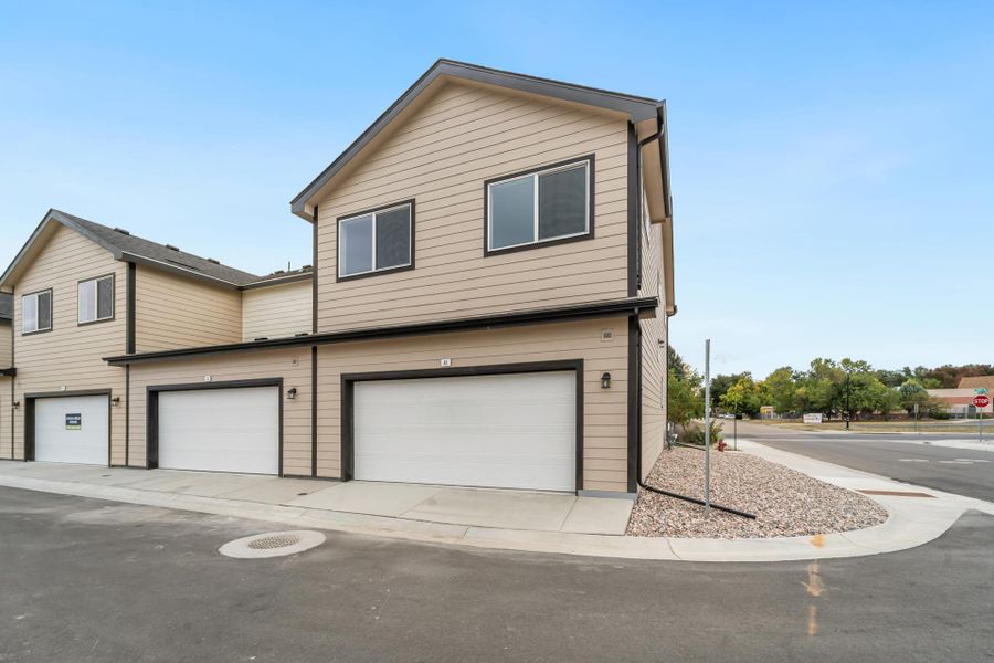 Front exterior of a new home in Conestoga, Ault, CO, highlighting curb appeal (Image 19). Front exterior of a new home in Conestoga, Ault, CO, highlighting curb appeal (Image 19).