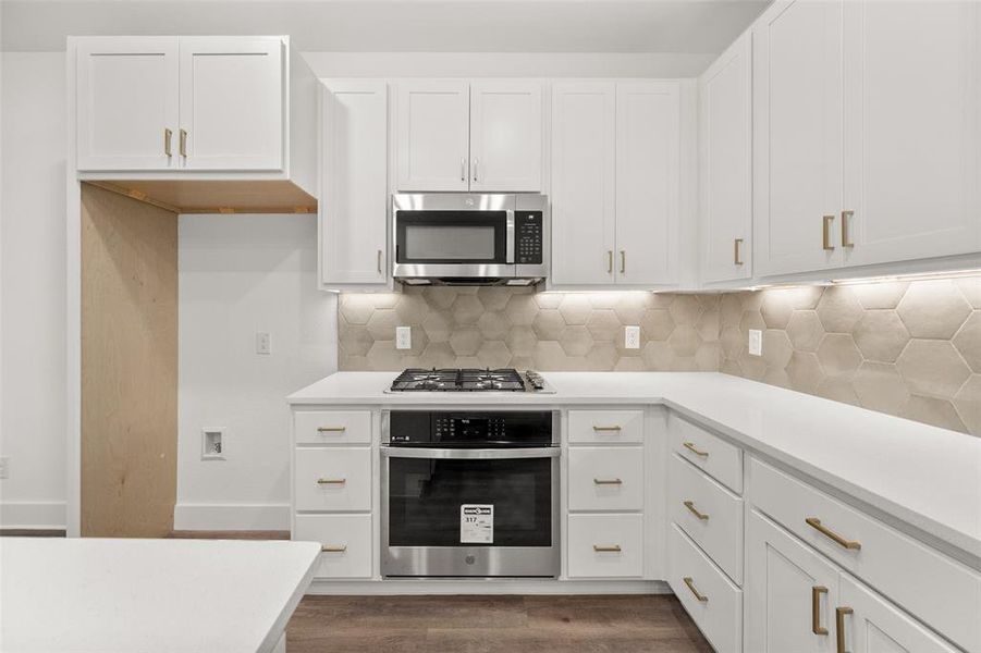 Kitchen with tile backsplash and stainless steel appliances