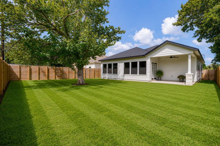 A well-maintained lawn and shaded patio provide an idyllic backyard retreat. A well-maintained lawn and shaded patio provide an idyllic backyard retreat.