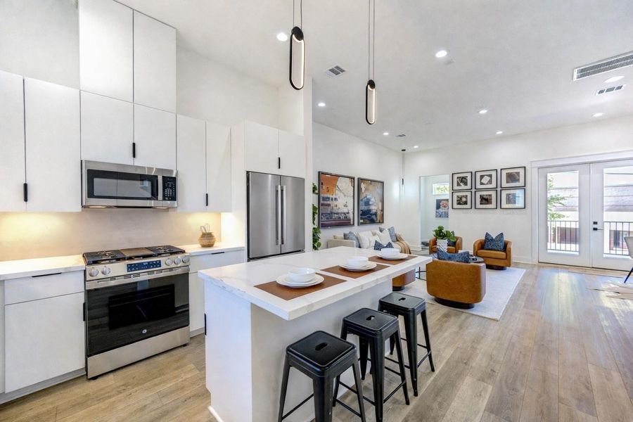 Open kitchen/living room combo area. (Refrigerator shown is virtually staged)