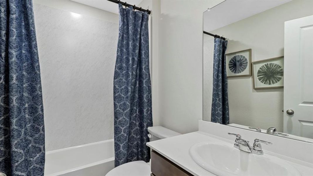 Bathroom with vanity and shower / bath combination with curtain