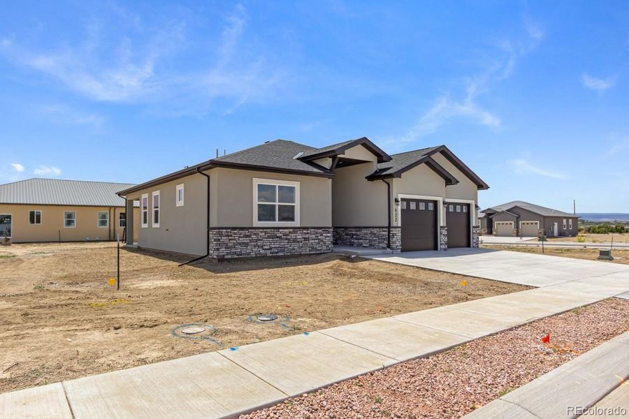 Front exterior of a new home in , Montrose, CO, highlighting curb appeal (Image 23). Front exterior of a new home in , Montrose, CO, highlighting curb appeal (Image 23).