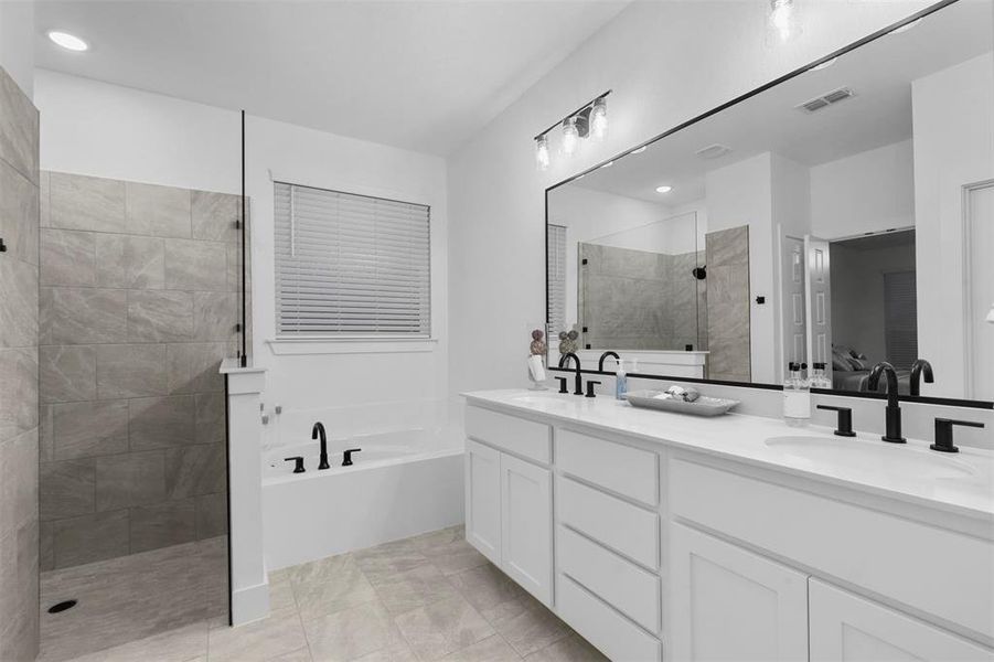 Bathroom with vanity, plus walk in shower, and tile patterned floors