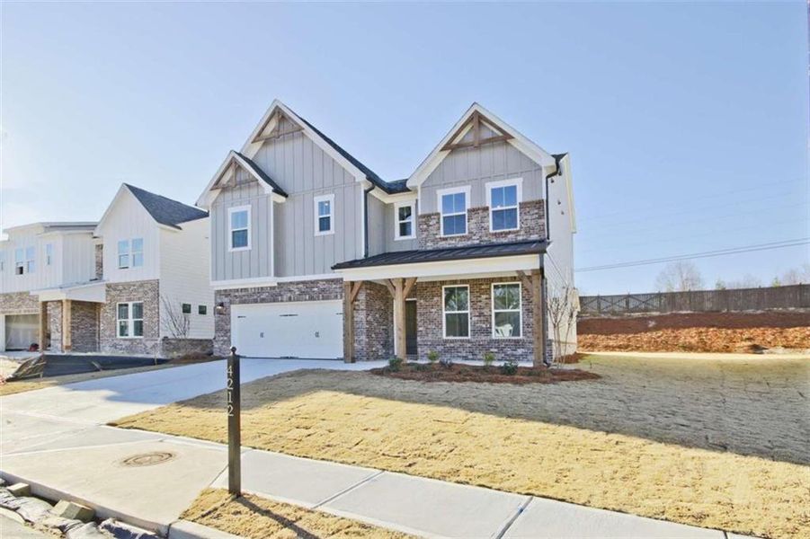 Front exterior of a new home in The Paddocks at Doc Hughes, Buford, GA, highlighting curb appeal (Image 2).
