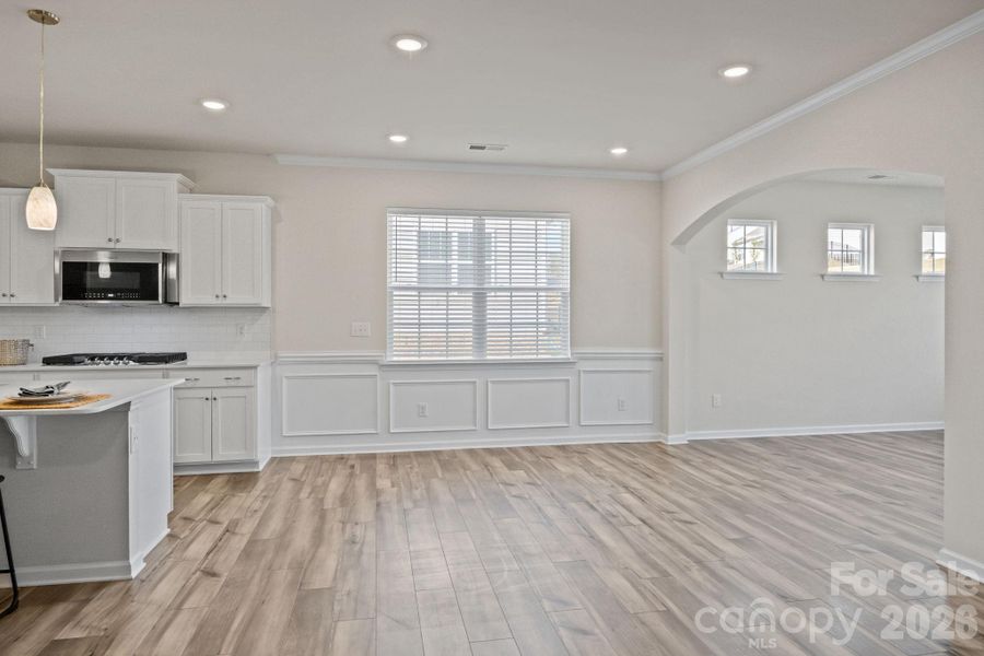 Architectural extra details! Breakfast/dining area with custom moldings leads through the arched entry to an additional space to be used as you wish!  Dining/keeping/game room?