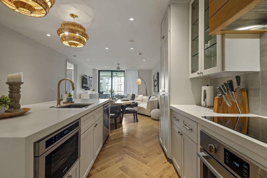 Herringbone hardwood floors extend from the gourmet kitchen into a welcoming living area.