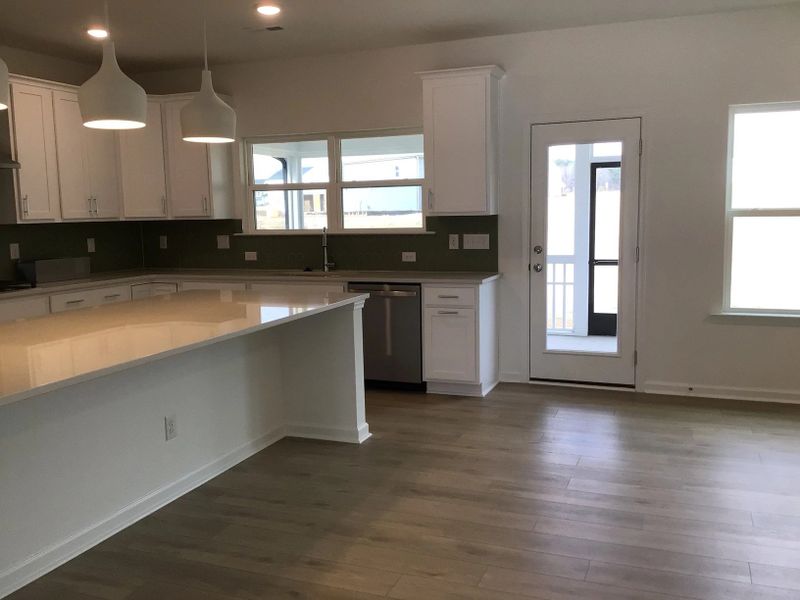 Kitchen featuring the AW Collection® Coastal - White cabinets and sea-glass tile backsplash.