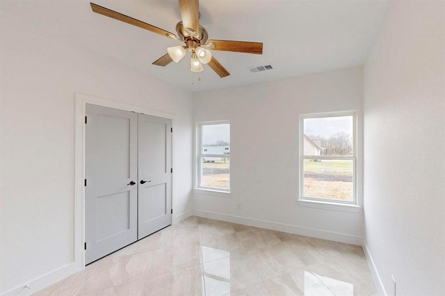 Unfurnished bedroom featuring ceiling fan and a closet