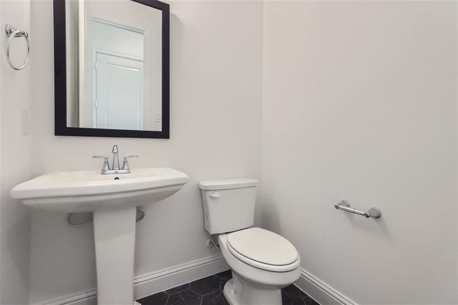 Bathroom featuring tile flooring and toilet